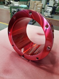 a red metal ring on a table in a factory